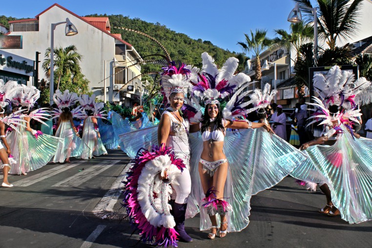 Beautifully dressed performers on a street at the Marigot Carnival